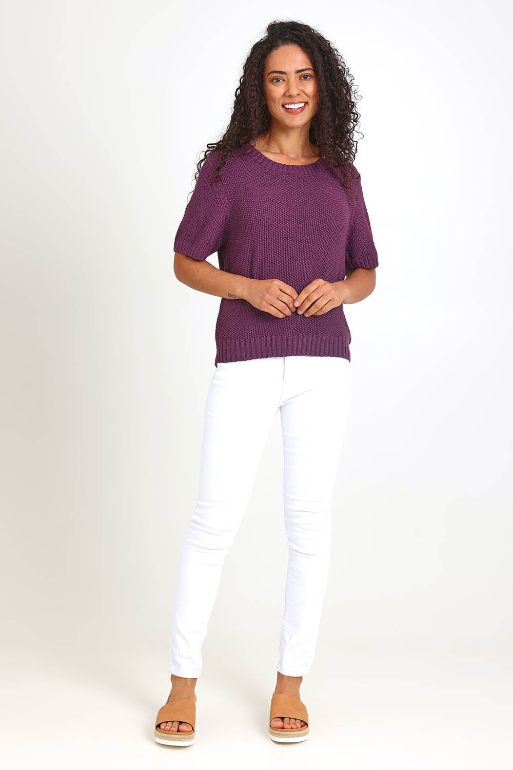 Model Pamelar wearing size 10 of the Blair Short Sleeve Knit – Plum in colour Plum, from the front