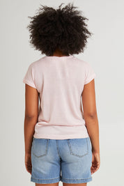 Model Olivia wearing size 10 of the Alma Metallic Knit in colour Barepink (Pink), from the back