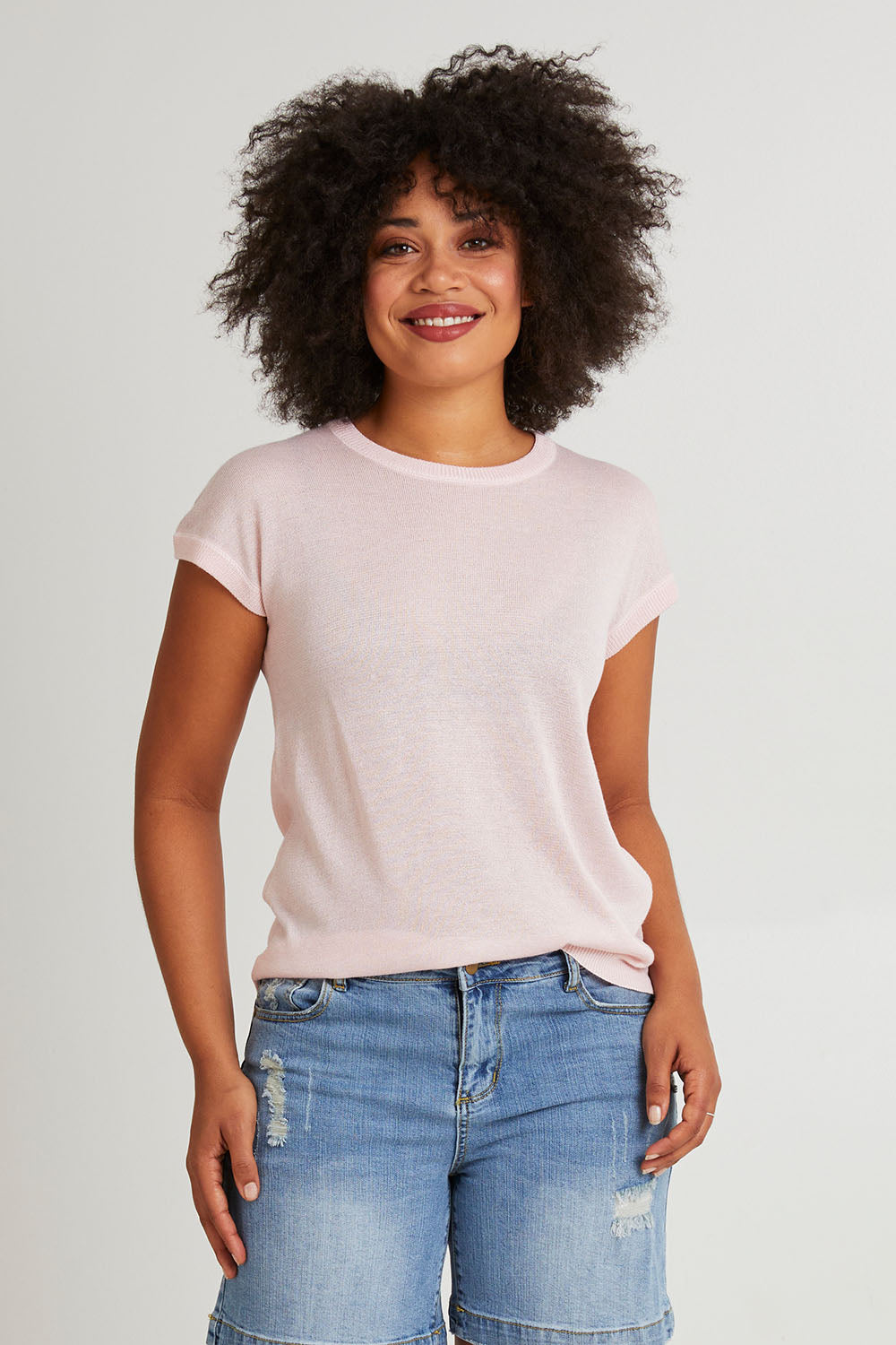 Model Olivia wearing size 10 of the Alma Metallic Knit in colour Barepink (Pink), from the front, cropped image