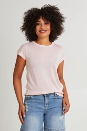 Model Olivia wearing size 10 of the Alma Metallic Knit in colour Barepink (Pink), from the front, cropped image