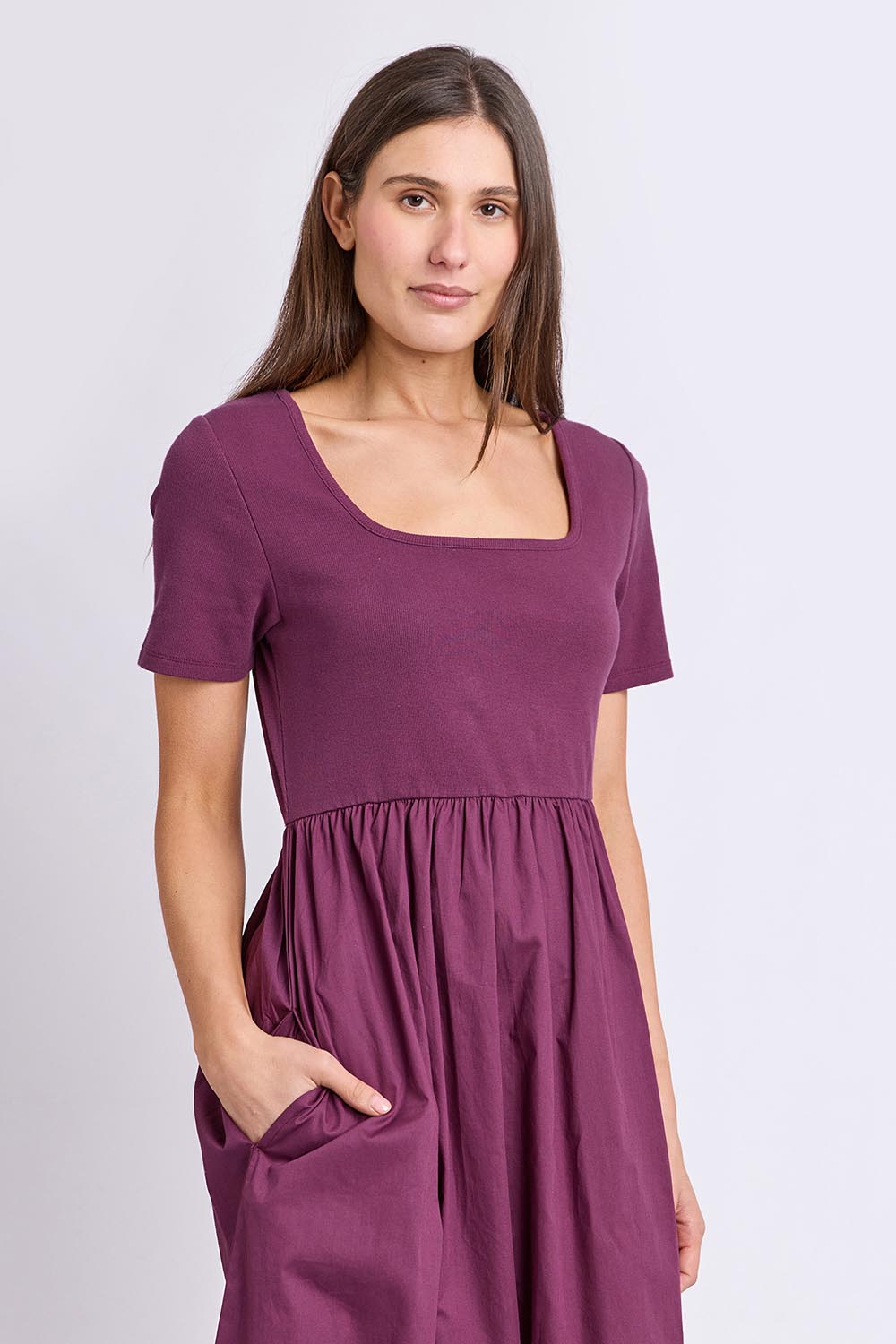 Model Genericm wearing size sample of the Ella Dress – Plum in colour Plum, in a cropped view