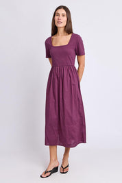 Model Genericm wearing size sample of the Ella Dress – Plum in colour Plum, from the front