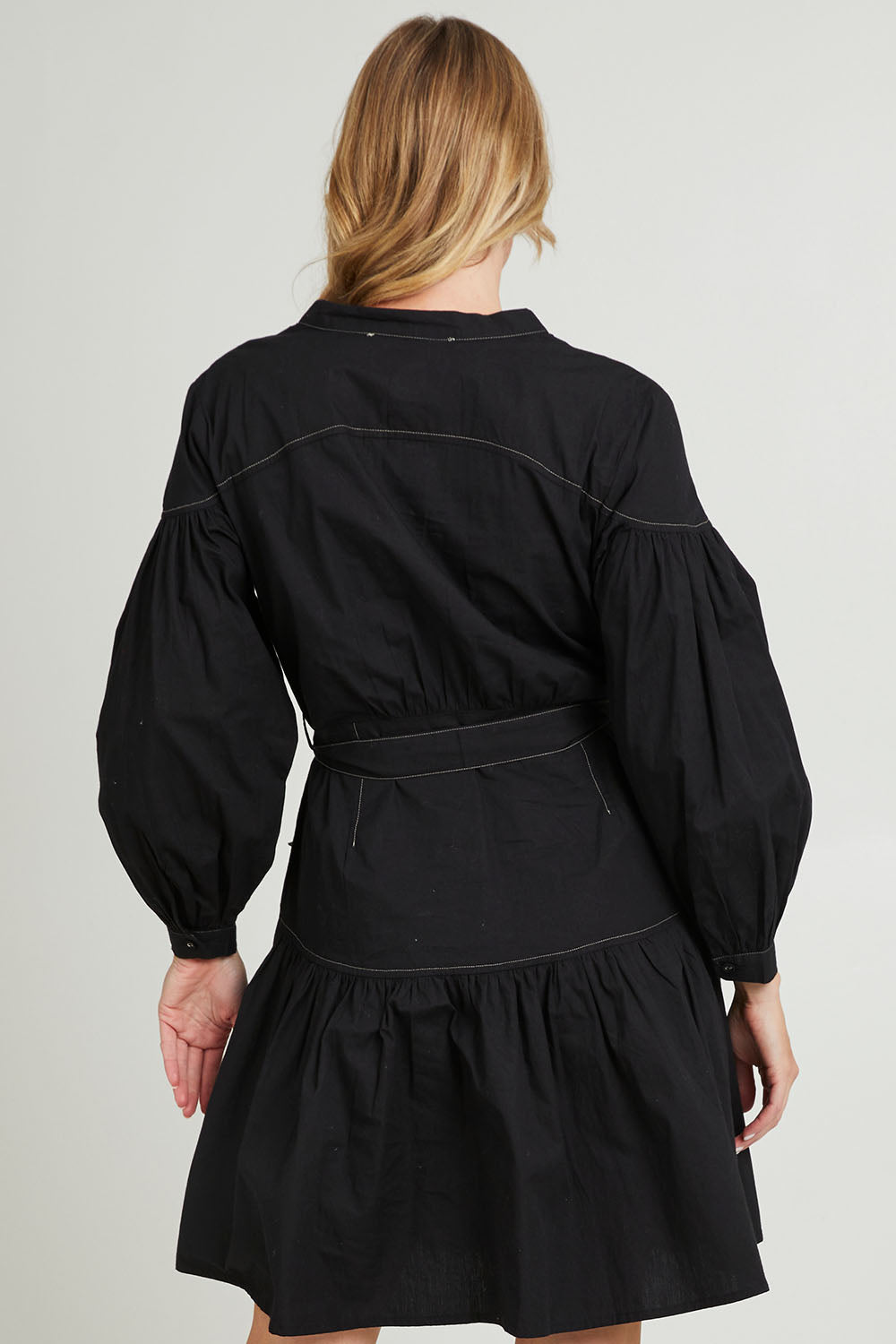 Model Grace wearing size 10 of the Goldie Dress in colour Black (Black), from the back