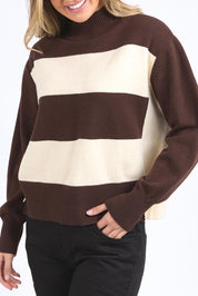 A model wearing the Canterbury Knit in colour Coffeevwhi, from the front, cropped image