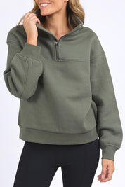 A model wearing the Elements College Zip Crew in colour Khaki (Green), from the front, cropped image