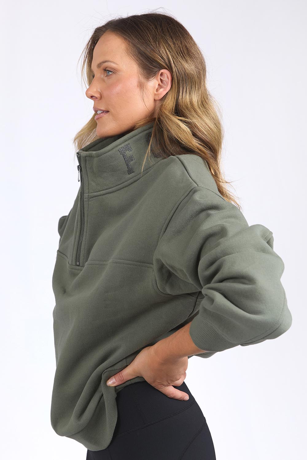 A model wearing the Elements College Zip Crew in colour Khaki (Green), from the front, cropped image
