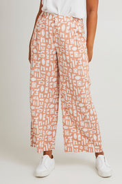 Model Olivia wearing size 10 of the Etched Geo Pant in colour Clay, from the front, cropped image