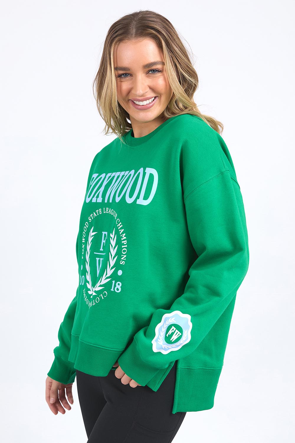 A model wearing the State League Cotton Crew in colour Green (Green), from the front, cropped image