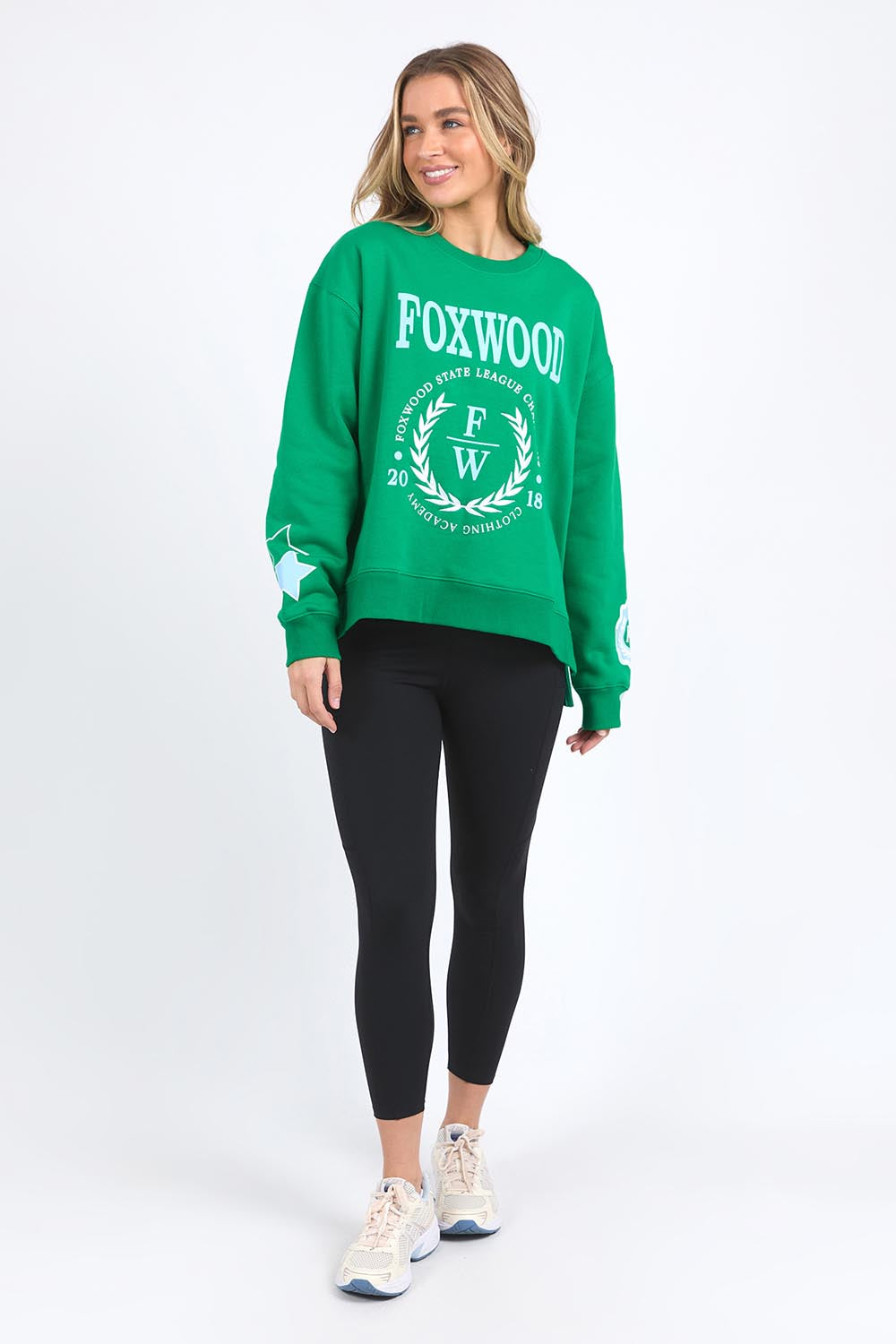 A model wearing the State League Cotton Crew in colour Green (Green), from the front, showing the whole outfit