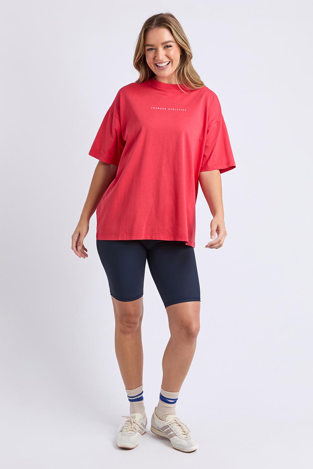 A model wearing the Leisure Captain Cotton Tee in colour Red (Red), from the front, showing the whole outfit
