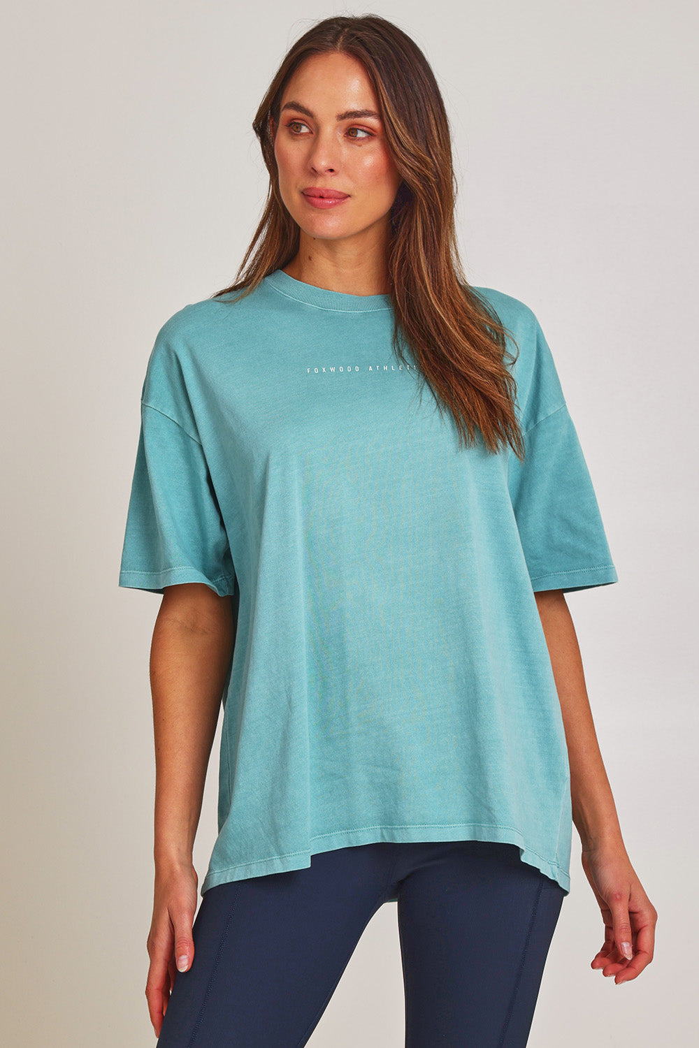 Model Madeline wearing size 10 of the Leisure Captain Cotton Tee in colour Sky (Blue), from the front, cropped image