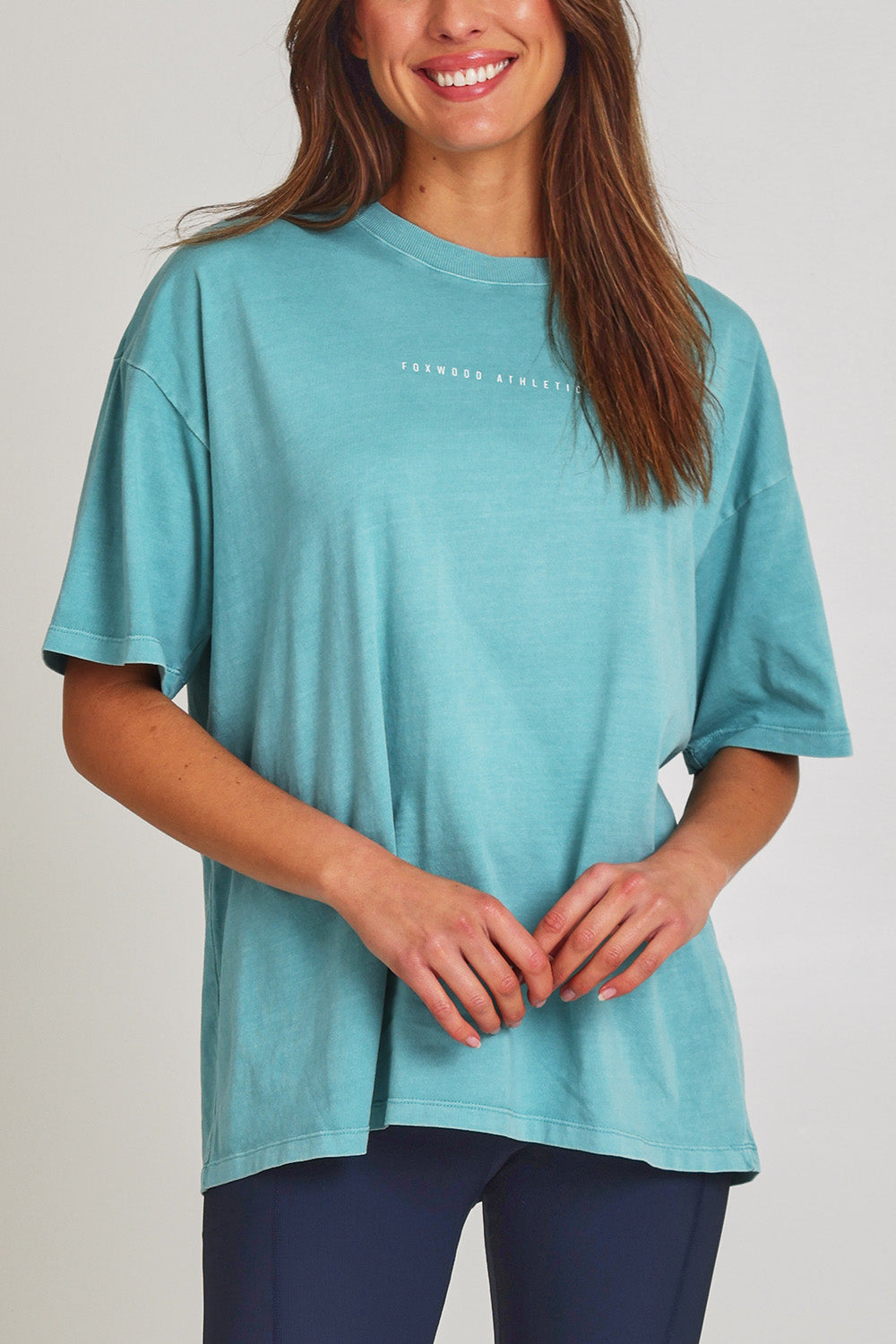 Model Madeline wearing size 10 of the Leisure Captain Cotton Tee in colour Sky (Blue), from the front, cropped image