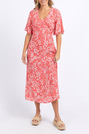 A model wearing the Ankara Dress in colour Red (Red), from the front, cropped image