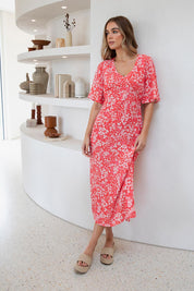 A model wearing the Ankara Dress in colour Red (Red), from the front, showing the whole outfit
