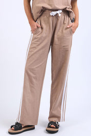 A model wearing the Leisure Power Cotton Pant in colour Mocha, from the front, cropped image