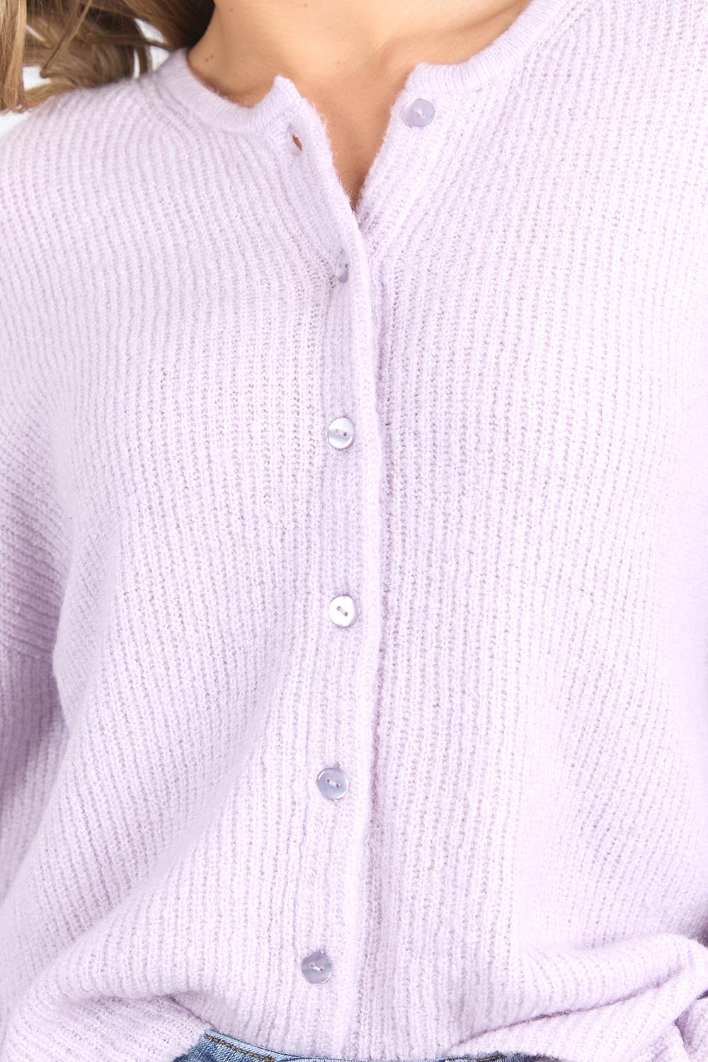 A model wearing the Murphy Knit Cardigan in colour Orchid (Purple), from the front, cropped image