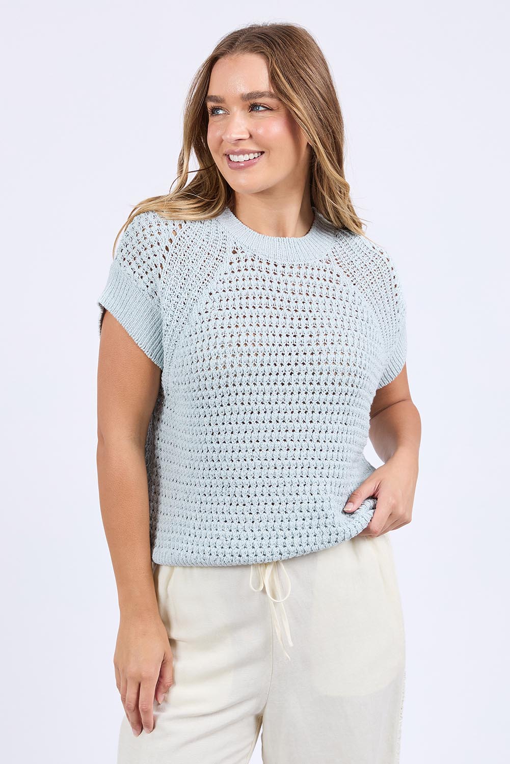 A model wearing the Isla Knit Vest in colour Balladblue (Blue), from the front, cropped image