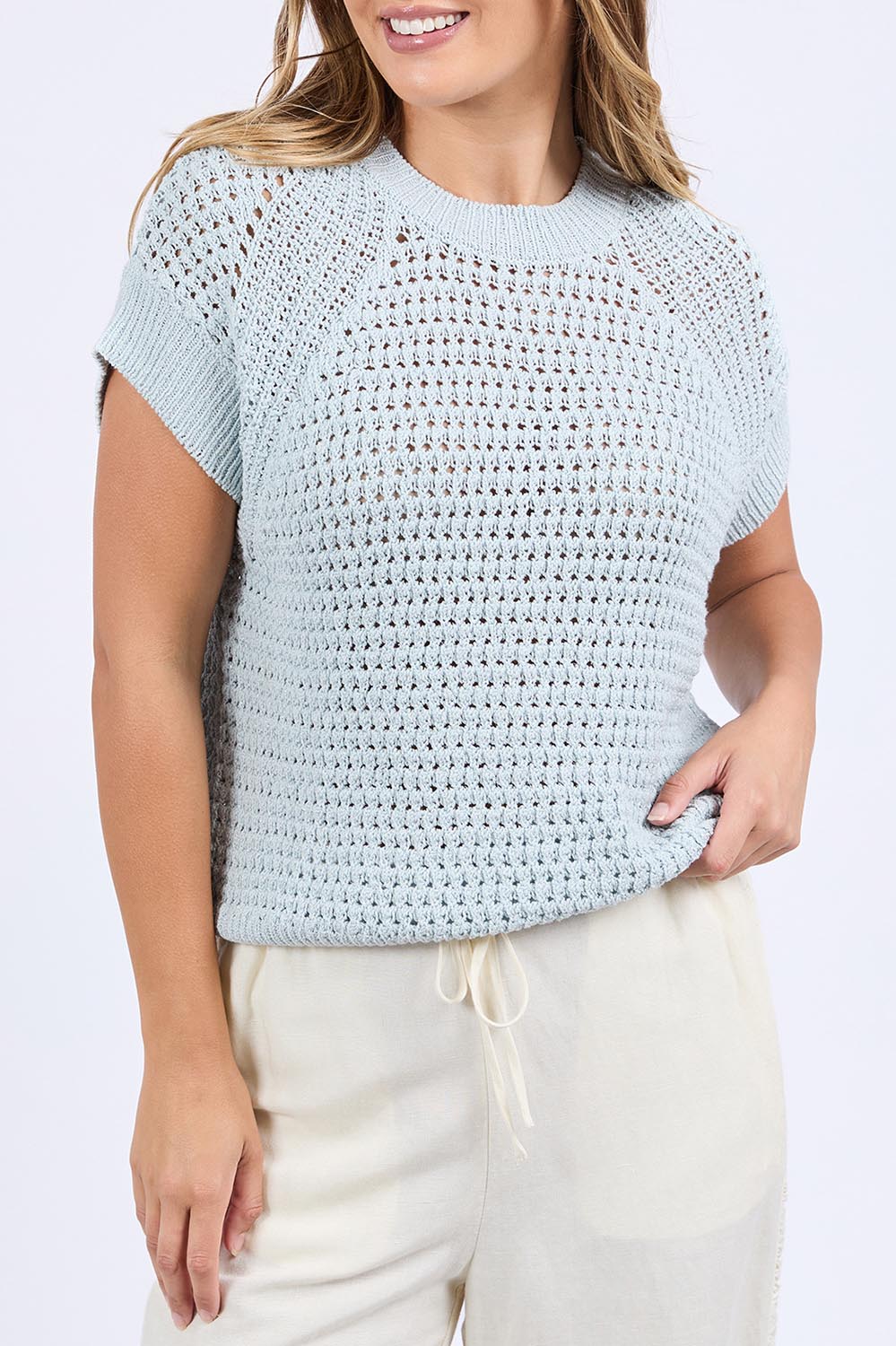 A model wearing the Isla Knit Vest in colour Balladblue (Blue), from the front, cropped image