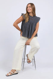 A model wearing the Adelyn Cotton Top in colour Charcoal (Grey), from the front, showing the whole outfit