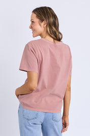 A model wearing the Pomegranate Cotton Tee in colour Ashrose (Pink), from the back