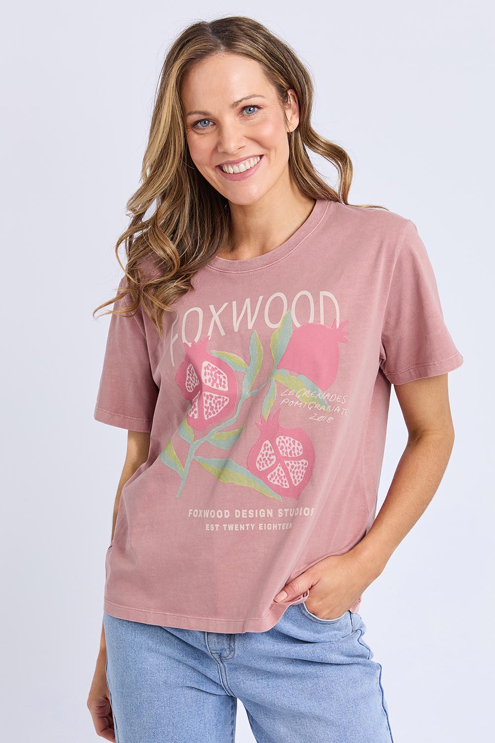 A model wearing the Pomegranate Cotton Tee in colour Ashrose (Pink), from the front, cropped image