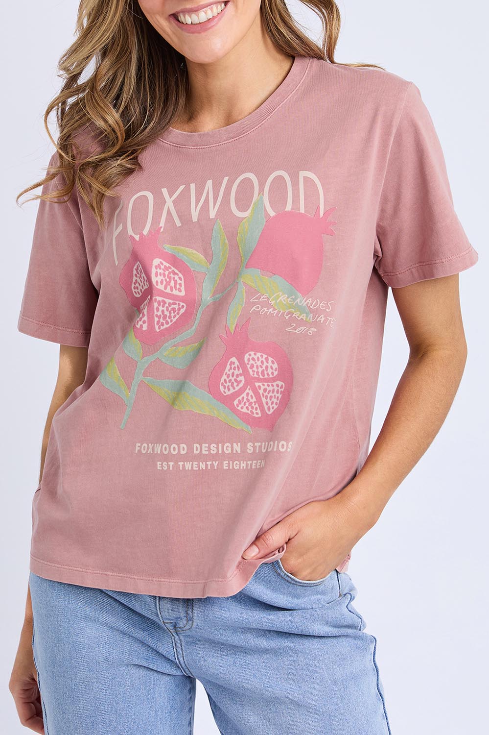 A model wearing the Pomegranate Cotton Tee in colour Ashrose (Pink), from the front, cropped image