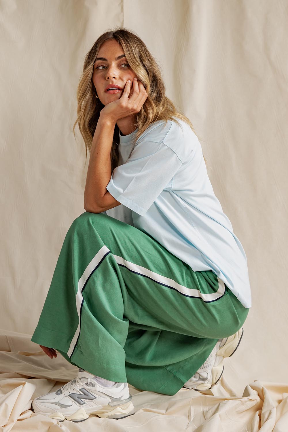 A model wearing the Elemental Linen Blend Pant in colour Deepgrass (Green), from the front, showing the whole outfit