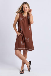 A model wearing the Paradise Cotton Linen Dress in colour Chocolate, from the front, showing the whole outfit