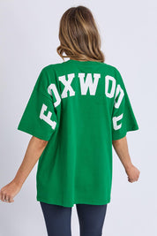 A model wearing the Interval Cotton Tee in colour Green (Green), from the back