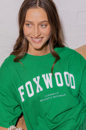 A model wearing the Interval Cotton Tee in colour Green (Green), from the front, showing the whole outfit