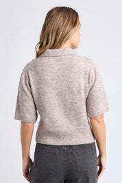 A model wearing the Fernie Button Knit in colour Oatmeal, from the back