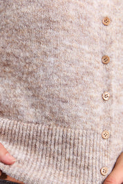 A model wearing the Fernie Button Knit in colour Oatmeal, from the front, cropped image