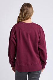 A model wearing the Solace Crew in colour Windwine (Red), from the back