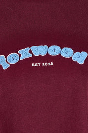 Product shot of the Solace Crew in colour Windwine (Red), detail