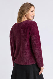 A model wearing the Kenny Button Cardi in colour Windwine (Red), from the back