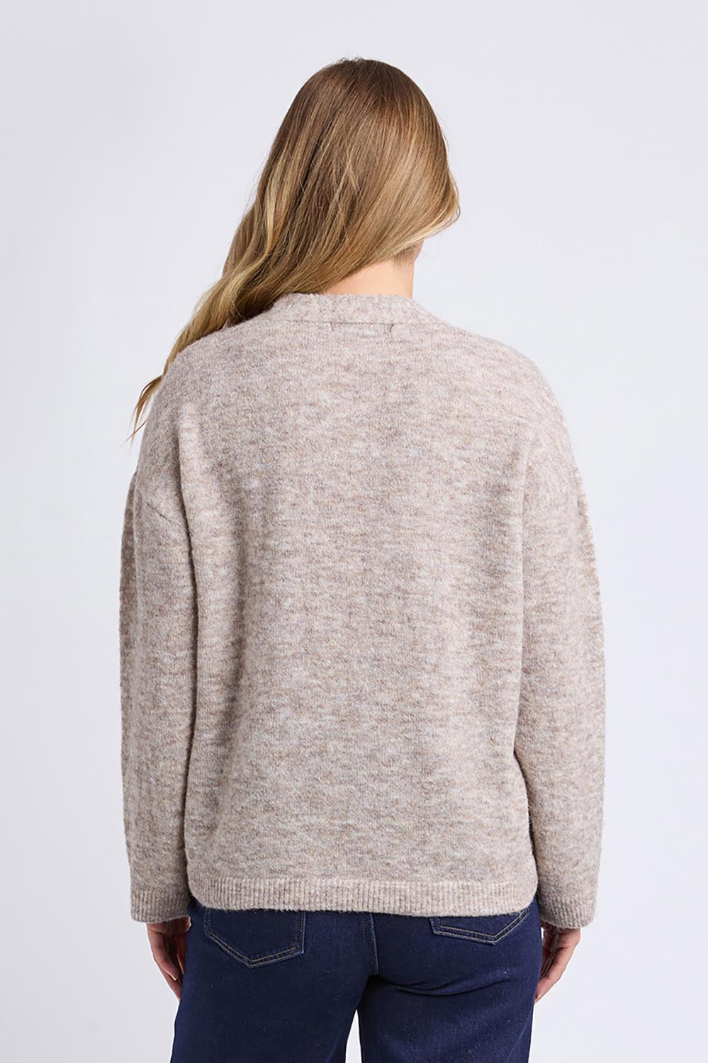 A model wearing the Emarie Cardi in colour Oatmeal, from the back