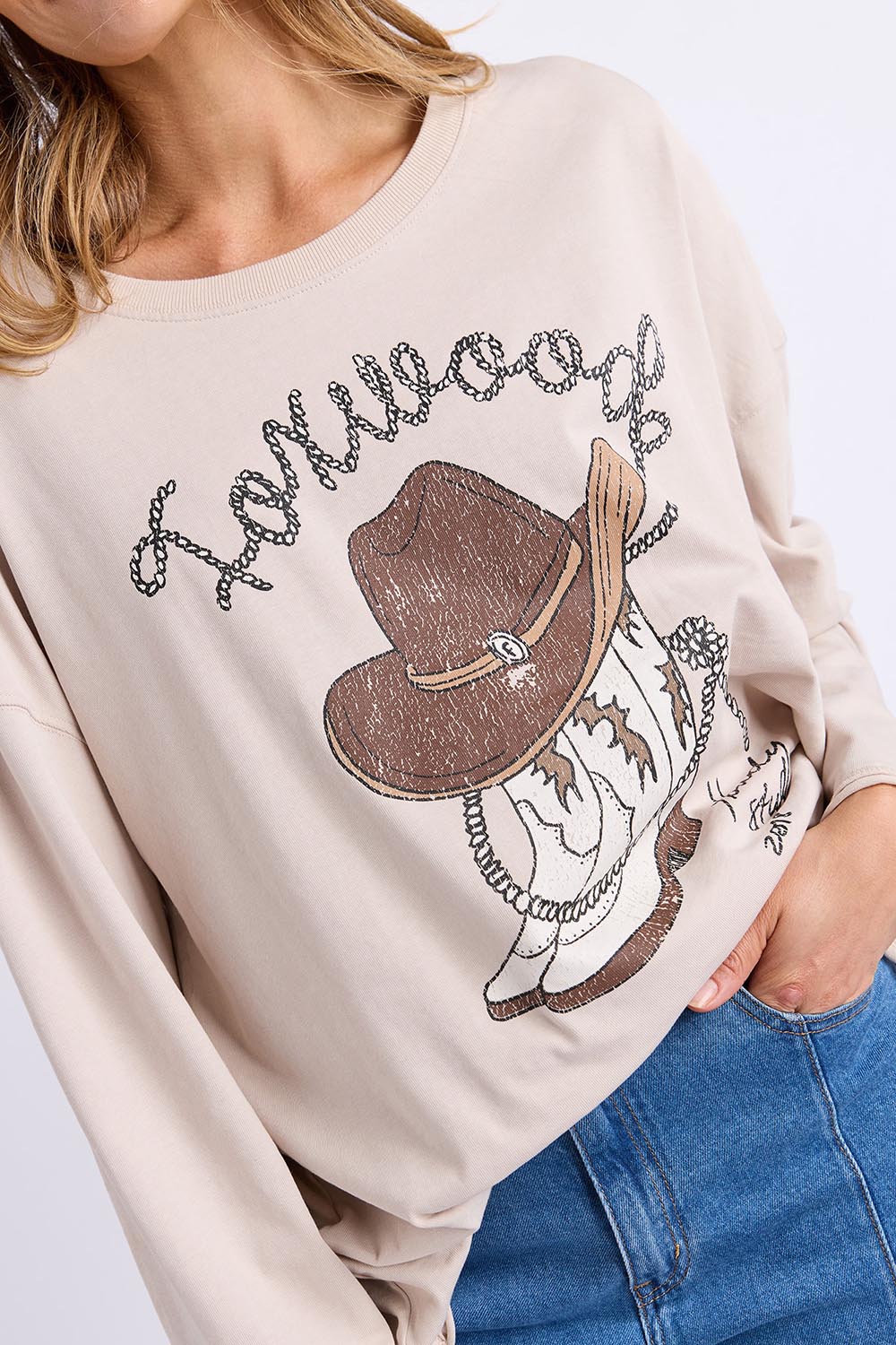 Model Genericm wearing size sample of the Bandit Boots Long Sleeve Tee – Oat in colour Oat, in a cropped view