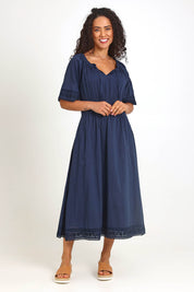 Model Pamelar wearing size 10 of the Juna Dress – Dsapphire in colour Dsapphire, from the front