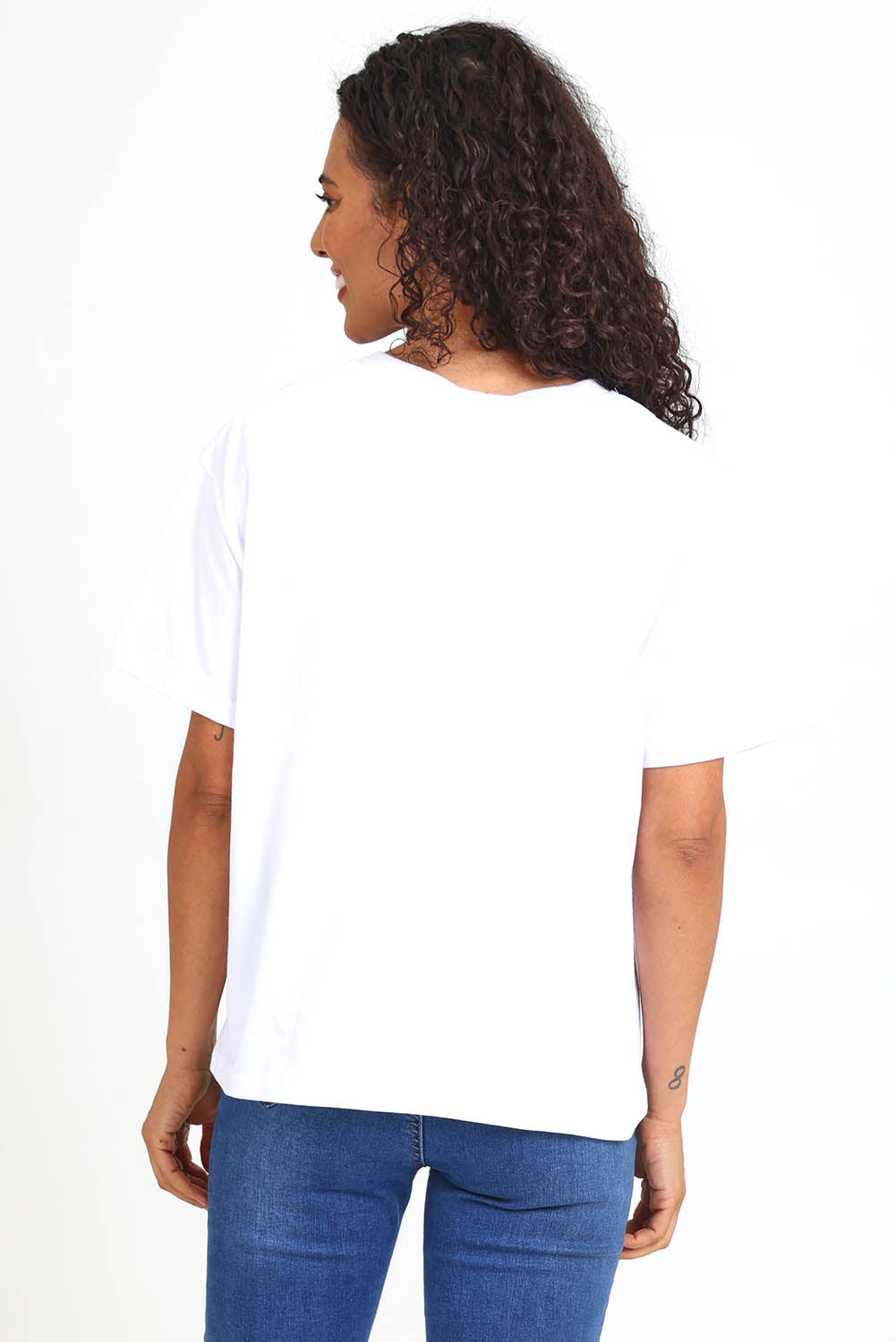 Model Pamelar wearing size 10 of the Studio Rose Tee – White in colour White, from an angle
