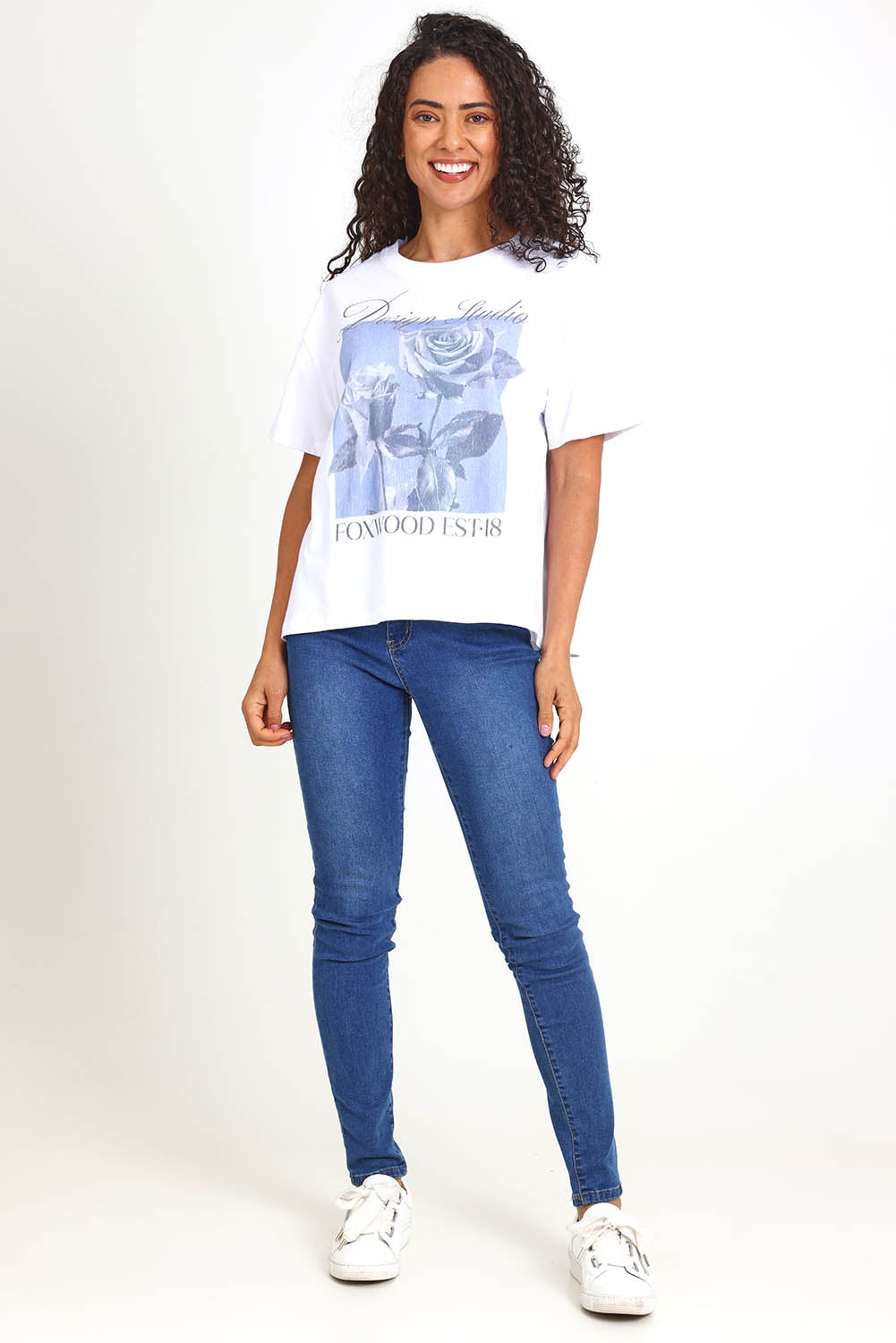 Model Pamelar wearing size 10 of the Studio Rose Tee – White in colour White, from the front