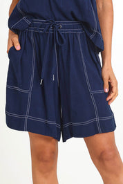 Model Pamelar wearing size 10 of the Sage Short – Dsapphire in colour Dsapphire, in a cropped view