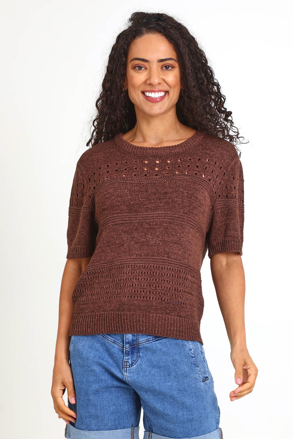 Model Pamelar wearing size 10 of the Sable Knit Top – Chocolate in colour Chocolate, in a cropped view