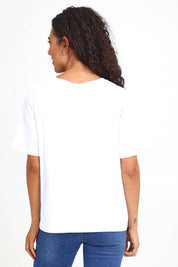 Model Pamelar wearing size 10 of the Fraiche Tee – White in colour White, from the back