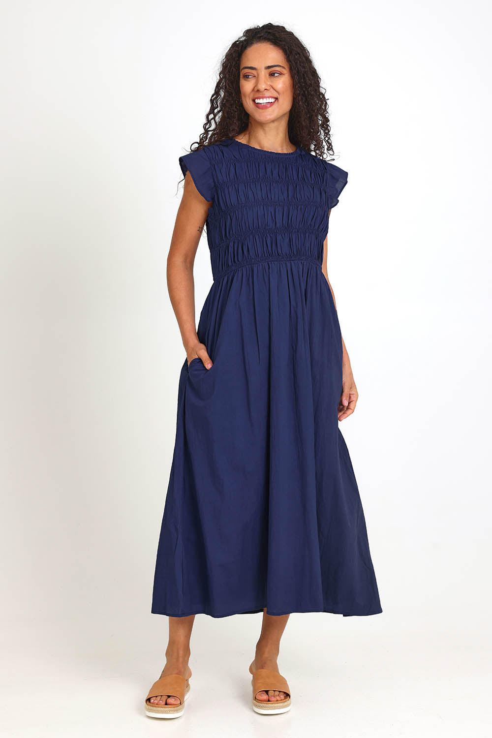 Model Pamelar wearing size 10 of the Memphis Dress – Deepblue in colour Deepblue, from the front