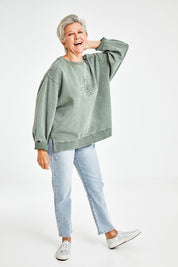 Model Elise wearing size 10 of the Everyday Crew in colour Greenmist (Green), from the front, showing the whole outfit