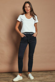 Model Madeline wearing size 10 of the Elements Sylvia Jogger in colour Navy (Blue), from the front, showing the whole outfit