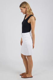 A model wearing the Elements Belle Skirt in colour Cloud (White), from the front, showing the whole outfit