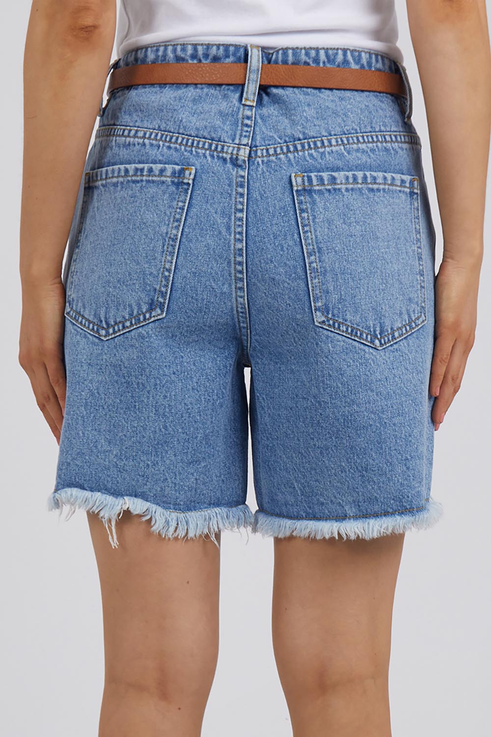 A model wearing the Elements Millie Short in colour Vintageblu (Blue), from the back