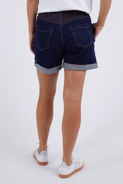 A model wearing the Elements Devi Denim Shorts in colour Darkblue (Blue), from the back