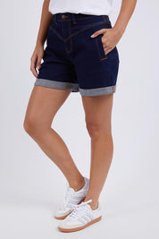 A model wearing the Elements Devi Denim Shorts in colour Darkblue (Blue), from the front, cropped image